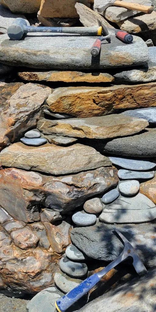 stone masonry building with tools around